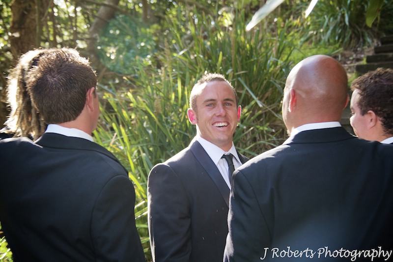Groom laughing back at the camera - wedding photography sydney